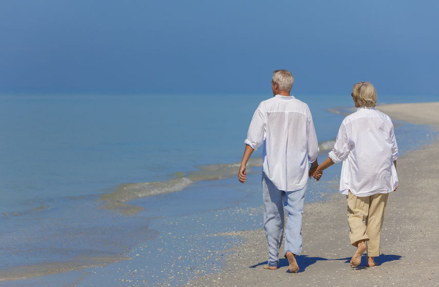 Couple walking on deserted beach