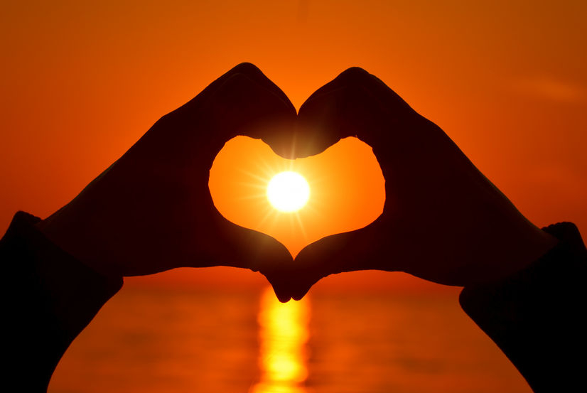 heart shape with hands on sunset