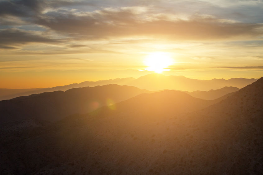 Glowing sunset view over the desert mountain landscape of Joshua Tree National Park