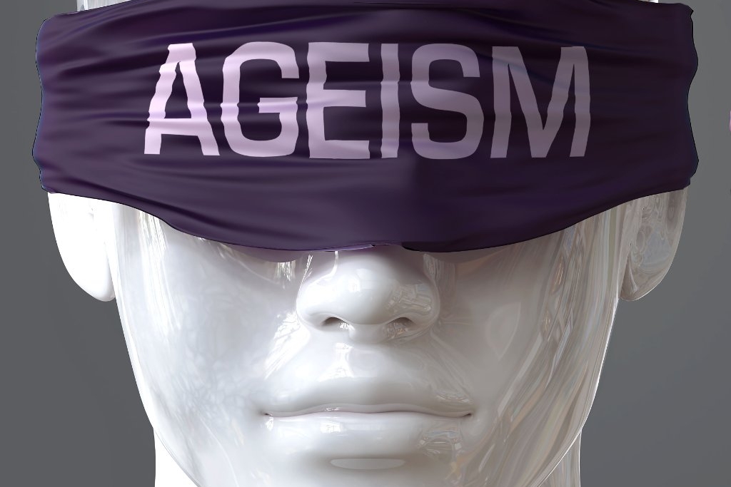 Ageism can blind our views and limit perspective - pictured as word ageism on eyes to symbolize that ageism can distort perception of the world