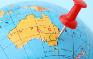 Image of Australia pinpointed on a globe with a red push pin