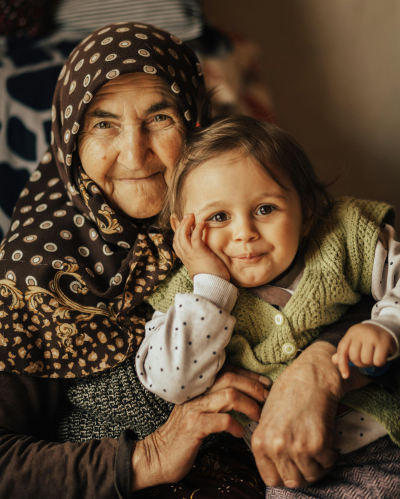 Grandmother and grandchild at family celebration of older loved one