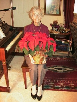 This Christmas photo was taken 10 years following my mother's diagnosis of Alzheimer's. That evening, we were energized by having sung many Christmas carols at the piano. I suggested we take her Christmas photo. Without saying a word, she picked up the poinsettia from the piano and sat down next to the piano ready to be photographed. This showed her quick response, understanding, and desire to get into the action. She liked being photographed.