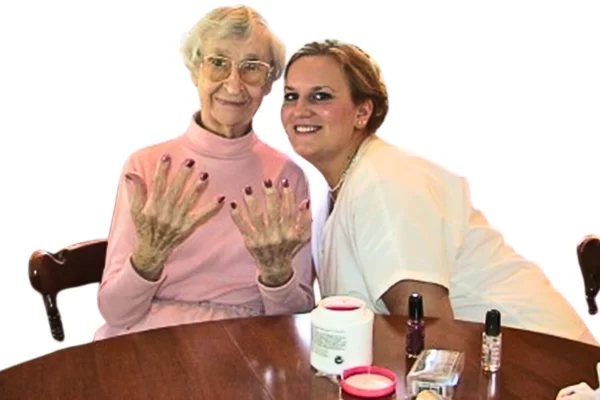 Miss Ethel is delighted with the manicure provided by a care partner who understands the importance of therapeutic touch in dementia care.