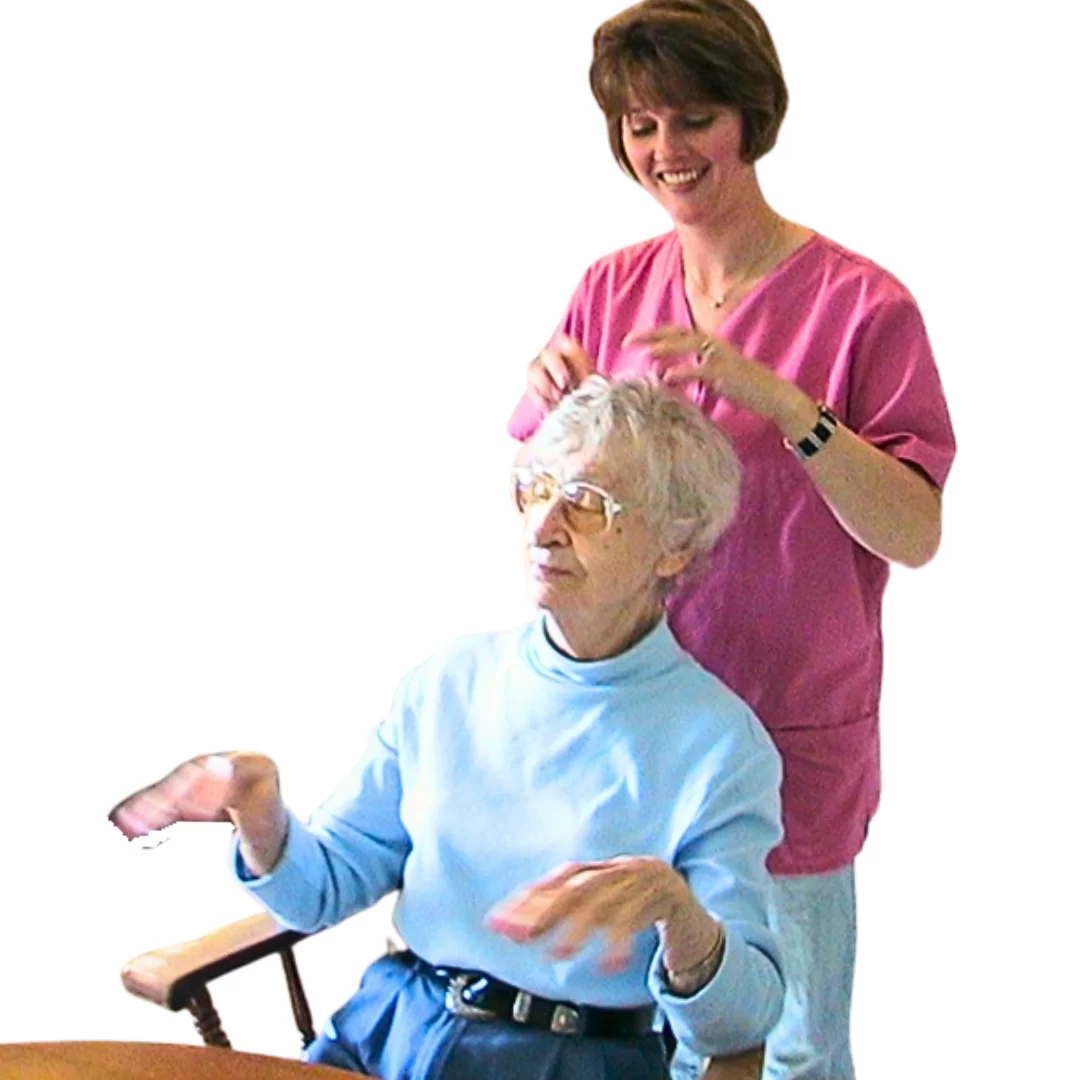 The therapeutic value of the care partner's touch during manicure and hair styling can be seen in Miss Ethel's peaceful demeanor. 
